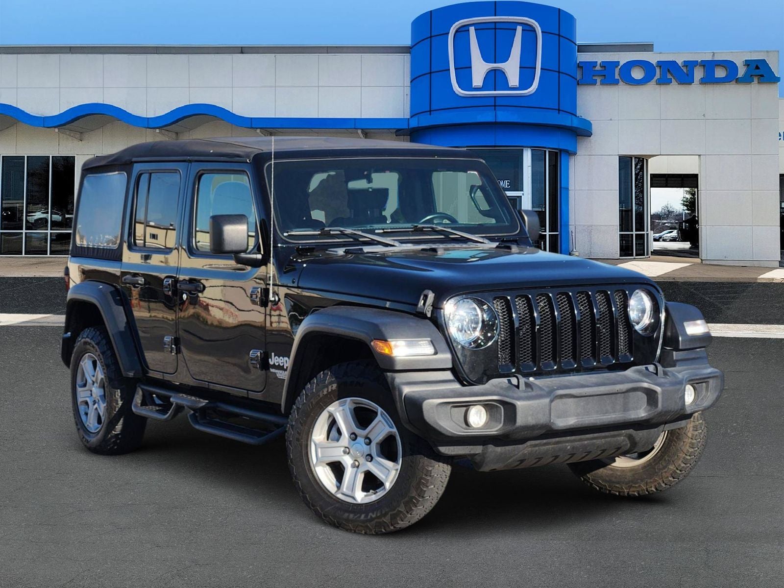 2021 Jeep Wrangler Unlimited Sport S in Black Clearcoat — front three-quarter view